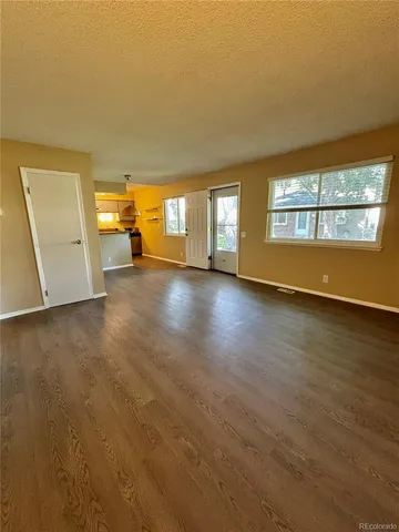 an empty room with a empty space and windows