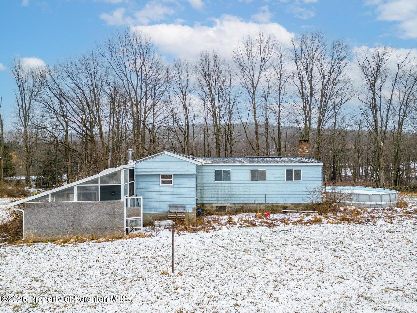 1777 Lamb Road Thompson, PA 18465 - Photo 29 of 31 a house with trees in the background