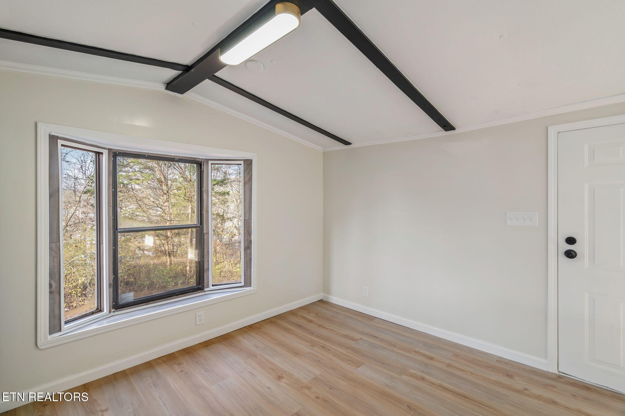 817 Vanessa Way Heiskell, TN 37754 - Photo 11 of 31 a view of an empty room with wooden floor and a window
