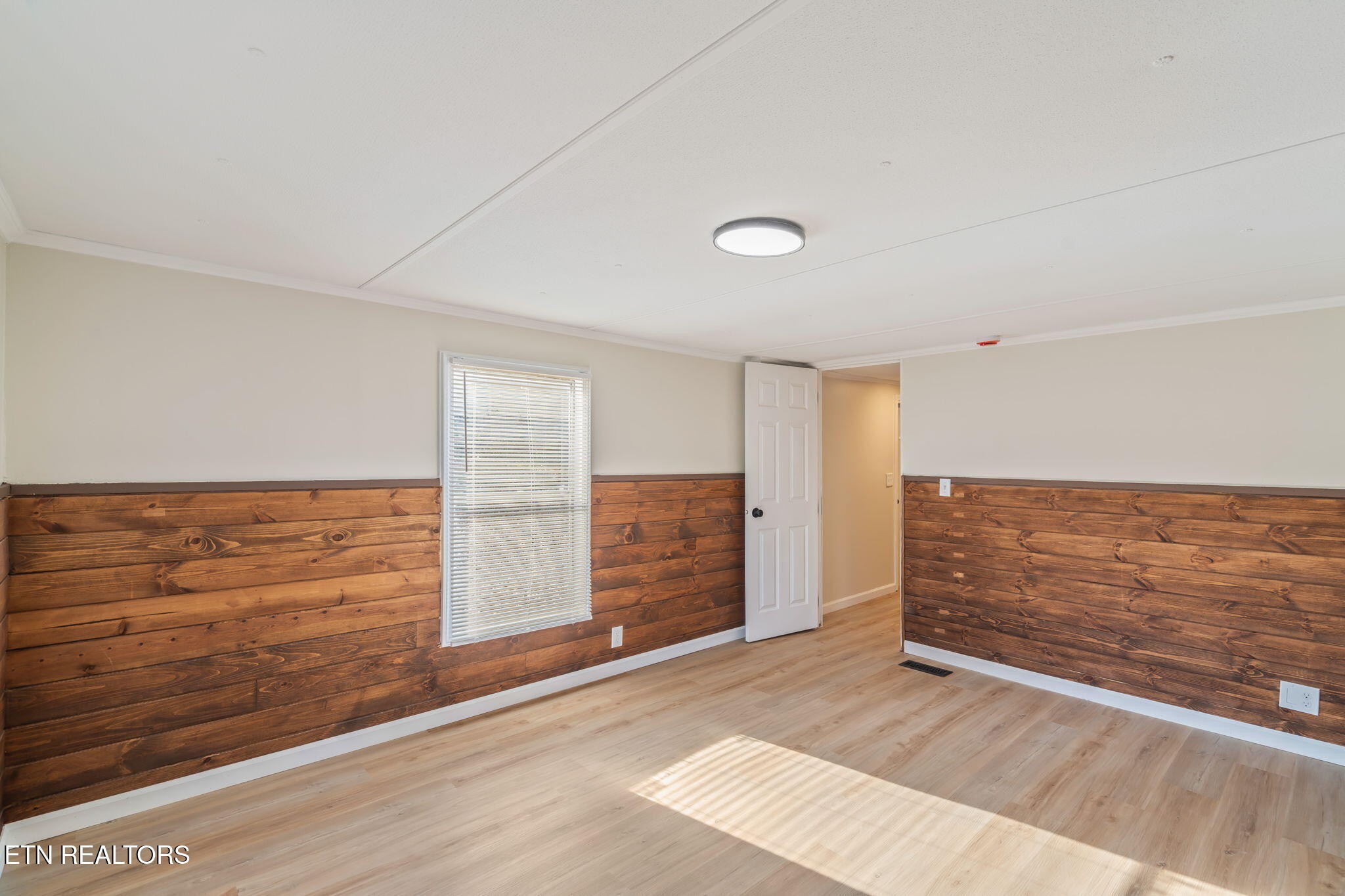 817 Vanessa Way Heiskell, TN 37754 - Photo 13 of 31 a view of an empty room with wooden floor and a window