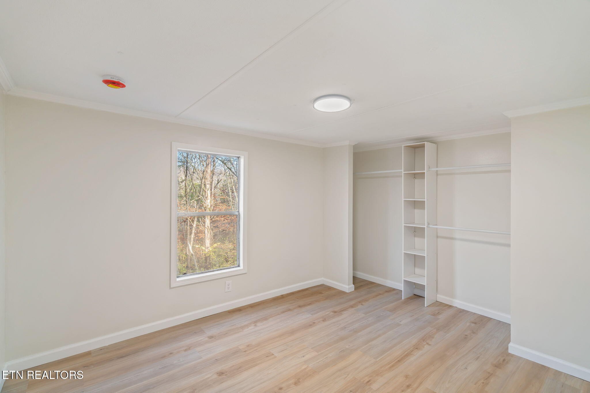 817 Vanessa Way Heiskell, TN 37754 - Photo 19 of 31 a view of an empty room with wooden floor and a window