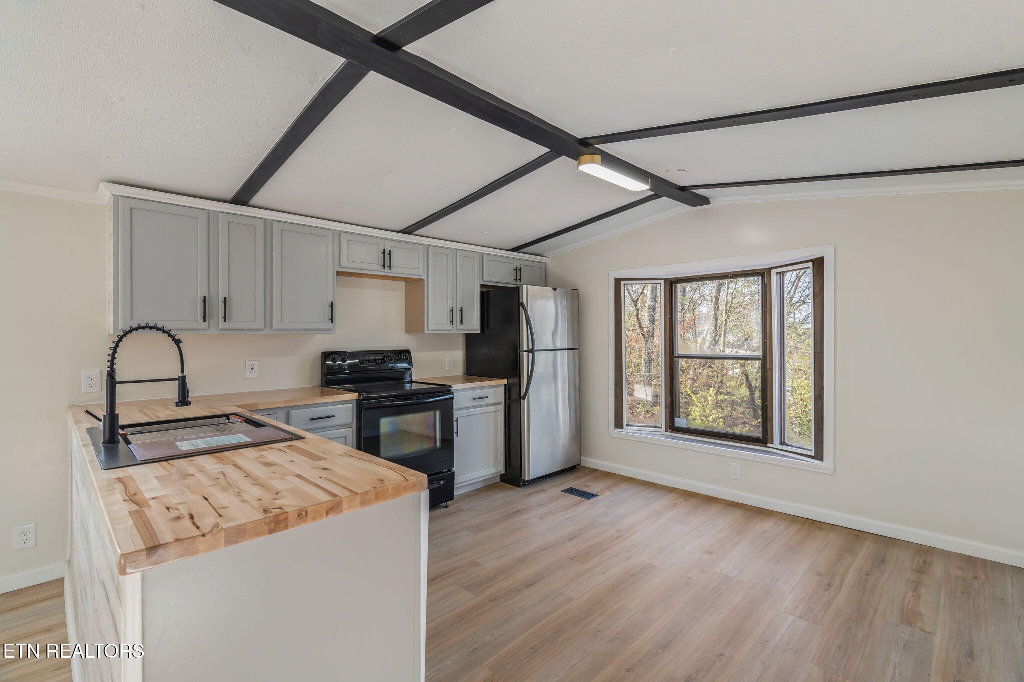 817 Vanessa Way Heiskell, TN 37754 - Photo 2 of 31 a kitchen with a stove a refrigerator and a sink