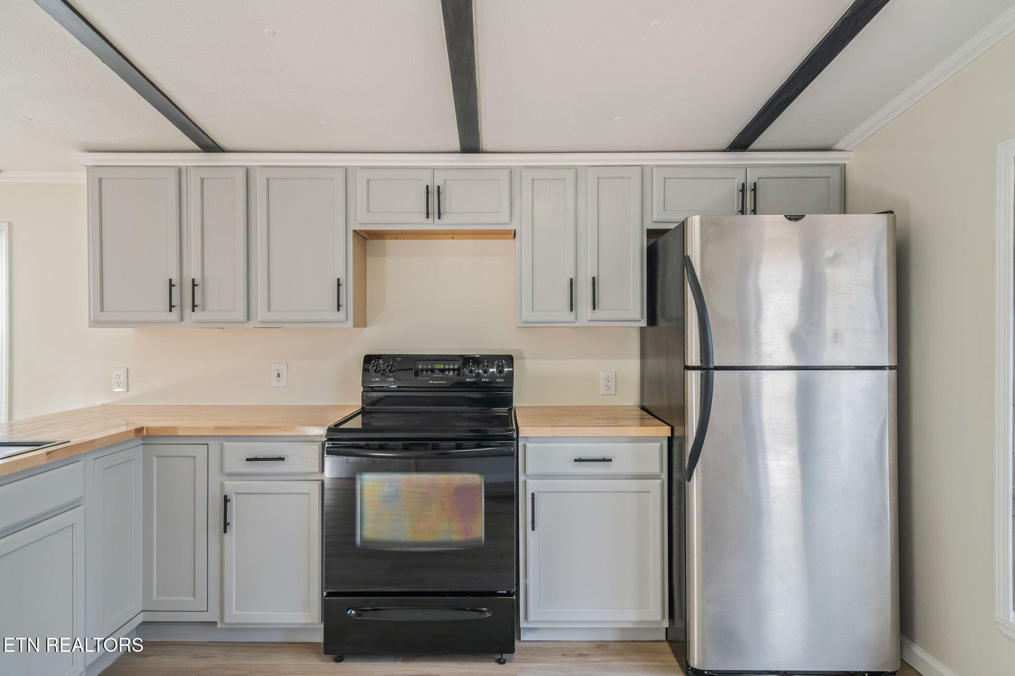 817 Vanessa Way Heiskell, TN 37754 - Photo 3 of 31 a kitchen with a refrigerator stove and white cabinets