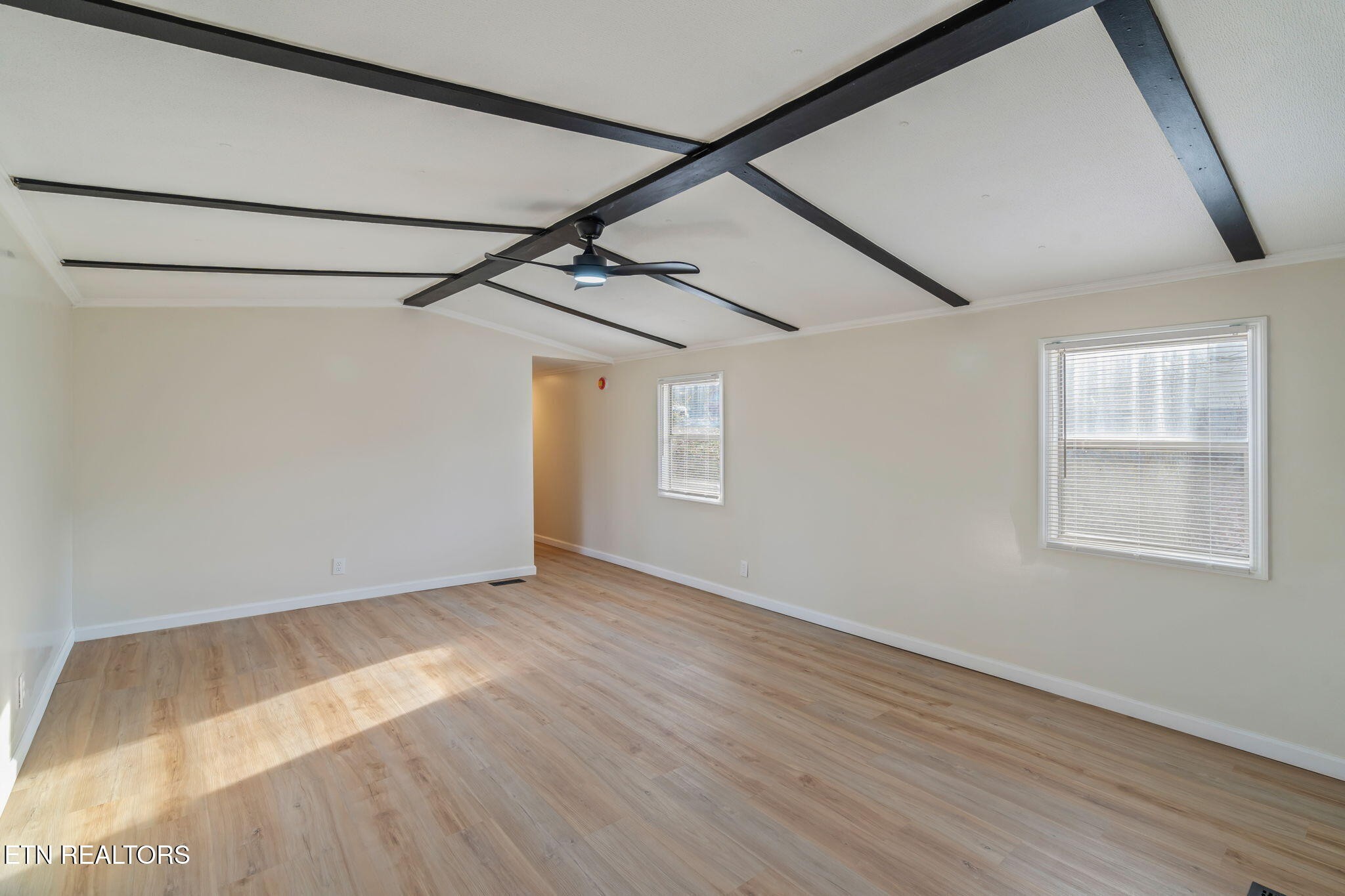 817 Vanessa Way Heiskell, TN 37754 - Photo 6 of 31 an empty room with wooden floor and windows