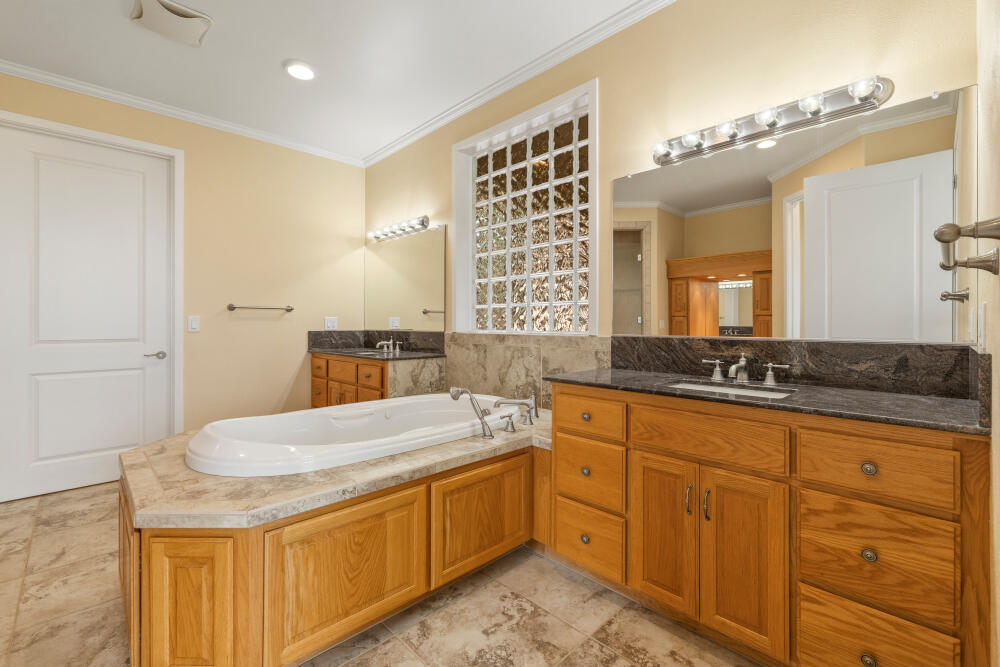 6586 Cooper's Hawk Road Klamath Falls, OR 97601 - Photo 23 of 68 a spacious bathroom with a granite countertop sink a mirror and a
