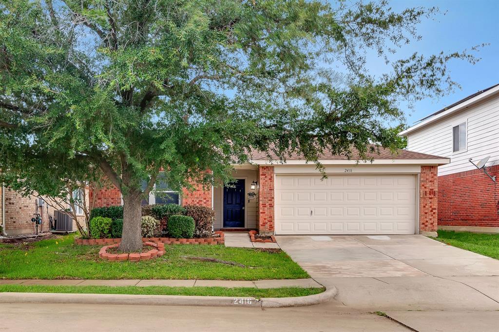 2416 Rolling Ridge Drive Little Elm, TX 75068 - Photo 1 of 1 a white house that has tree in front of it