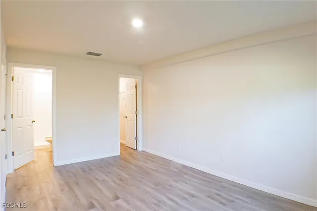 a view of an empty room and wooden floor