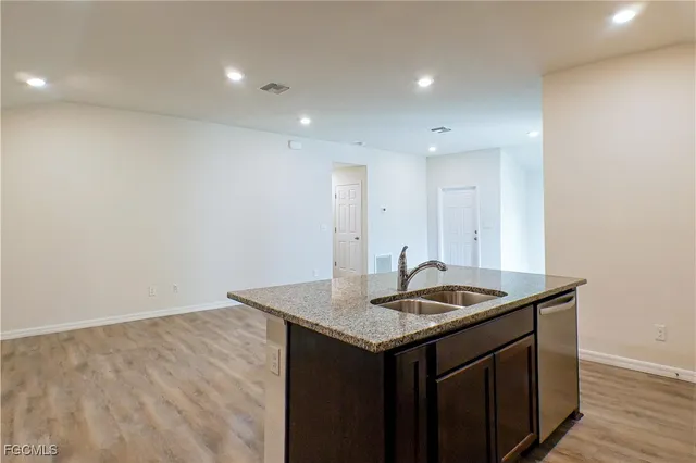 a kitchen with a sink and cabinets