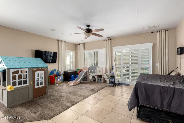a living room with furniture a flat screen tv and a large window