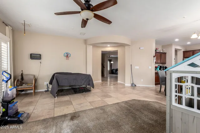 a living room with furniture and a book shelf