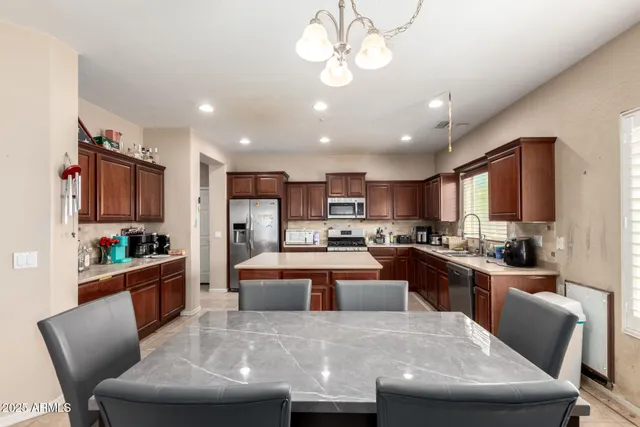 a large kitchen with cabinets table and chairs