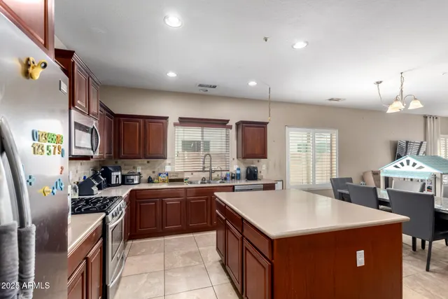 a kitchen with a sink a counter top space a stove and cabinets