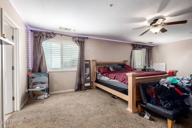 a bed room with a bed and a chair