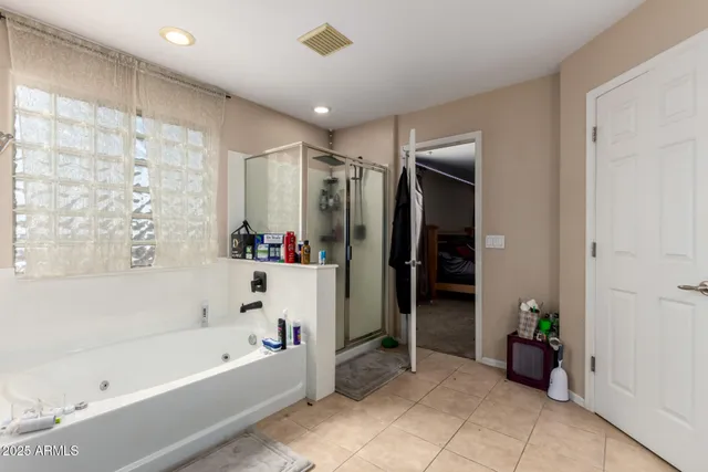 a bathroom with a bathtub and a shower