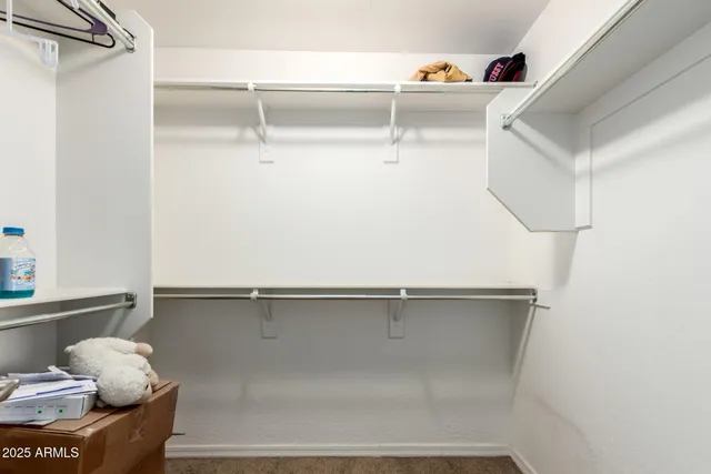 a bedroom with a bed couch and window