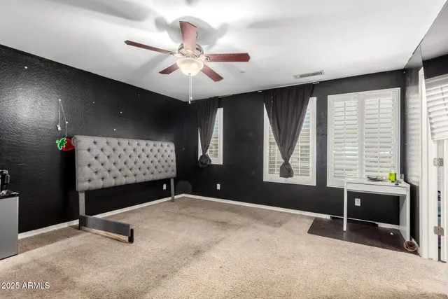 a bedroom with furniture and a flat screen tv