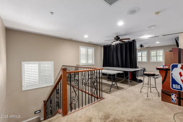 a living room with stainless steel appliances furniture and a refrigerator