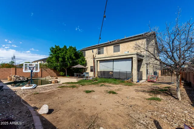 a view of a house with swimming pool and sitting area