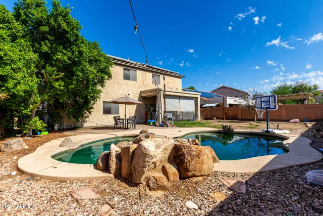 a front view of a house with garden and patio