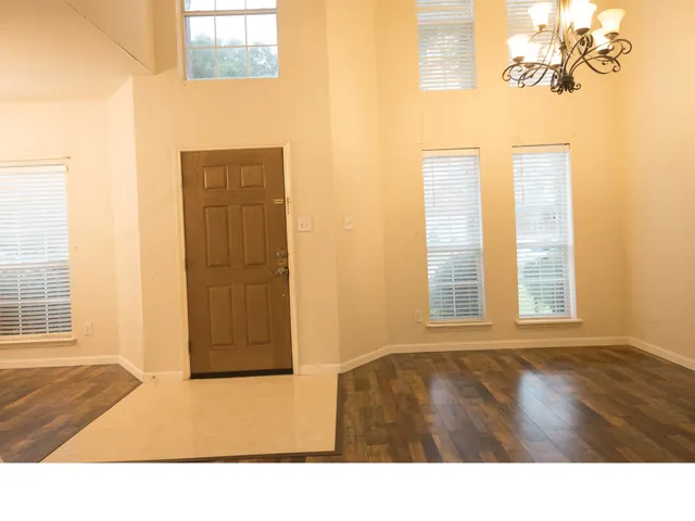a room with a window and wooden floor