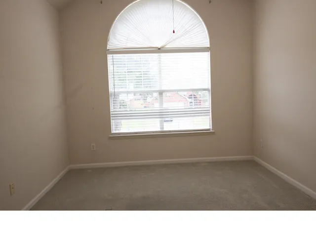 a room with a window and a wooden floor