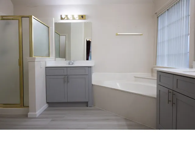 a bathroom with a sink a mirror and a bathtub
