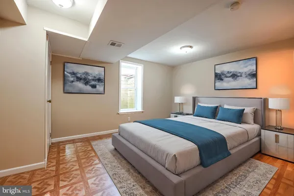 a bedroom with a large bed and a window