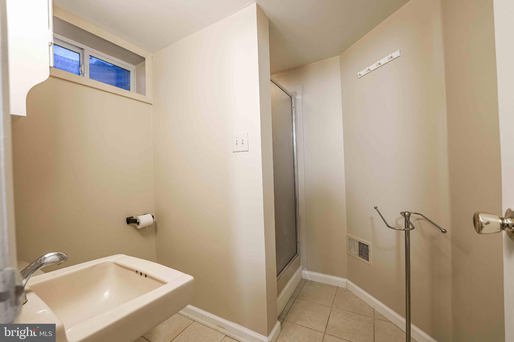 6809 Weaver Avenue, Unit B McLean, VA 22101 - Photo 6 of 11 a bathroom with a sink and shower