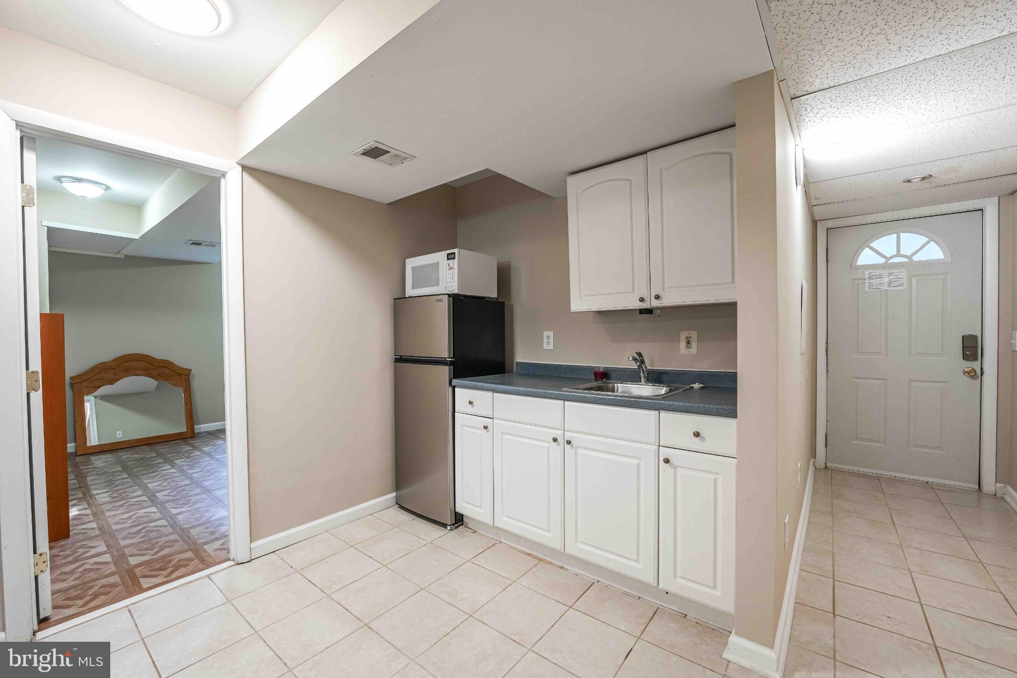 6809 Weaver Avenue, Unit B McLean, VA 22101 - Photo 10 of 11 a kitchen with a sink and cabinets