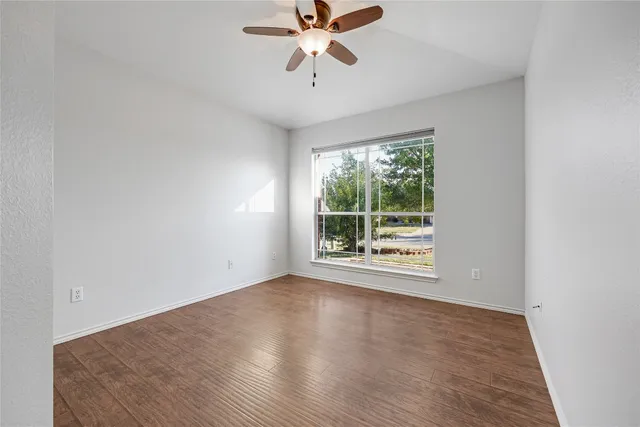 a view of a room with window and a ceiling fan
