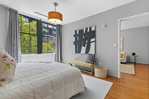 a bedroom with a bed and a chandelier