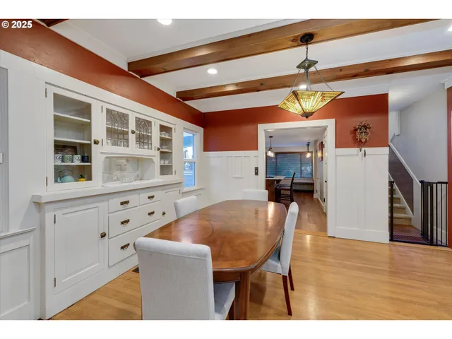 a dining room with furniture and wooden floor