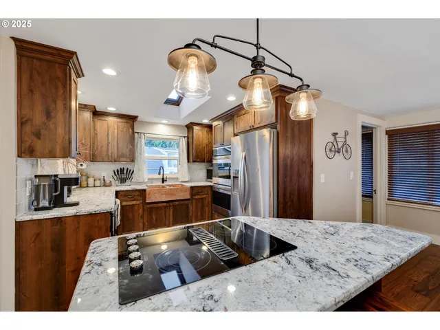 a kitchen that has a lot of cabinets a sink and a refrigerator