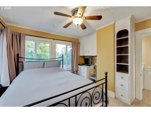 a view of kitchen with cabinets and window