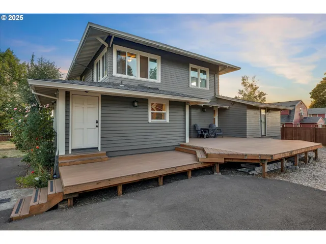 a backyard of a house with barbeque oven table and chairs