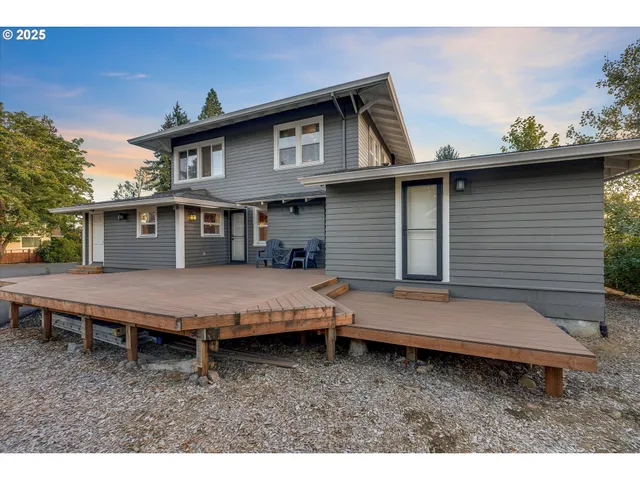 a backyard of a house with barbeque oven table and chairs