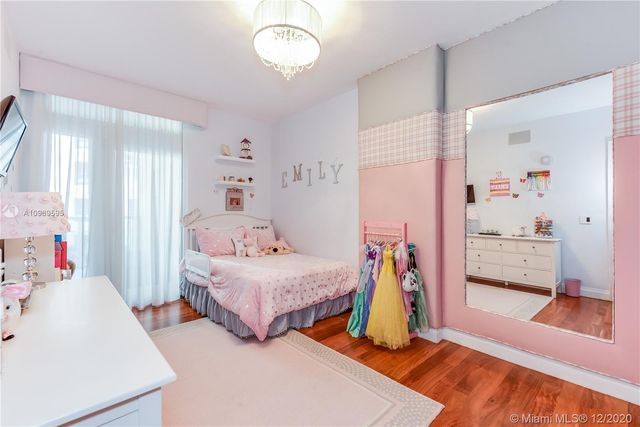 a bedroom with two beds and a large dresser