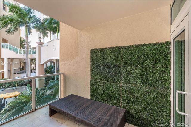 a view of a balcony with yard