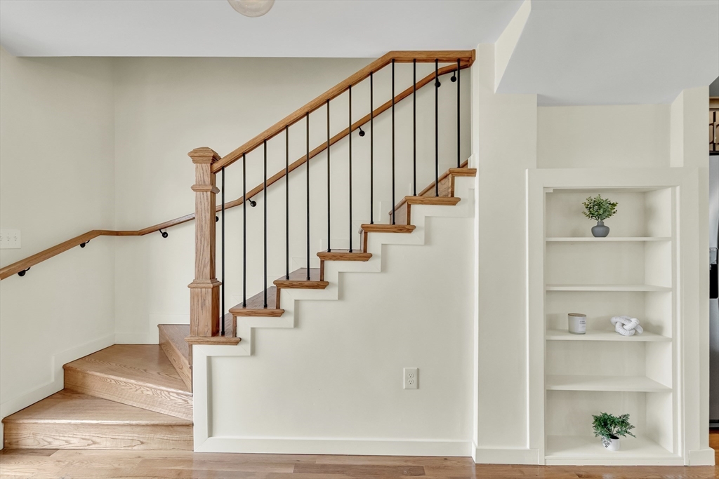 56 Riverview Street Dedham, MA 02026 - Photo 10 of 29 a view of staircase with lots of frames on wall and a window