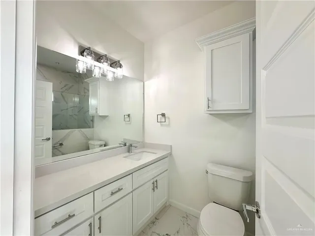 a bathroom with a glass shower door