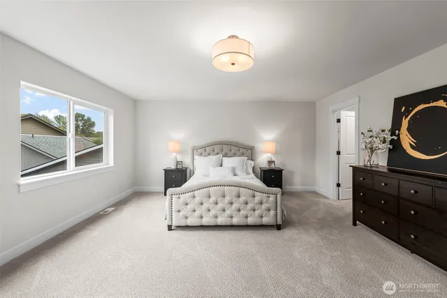 a bedroom with a bed and a couch