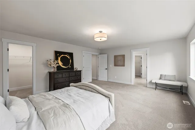 a bed sitting in a bedroom next to a window