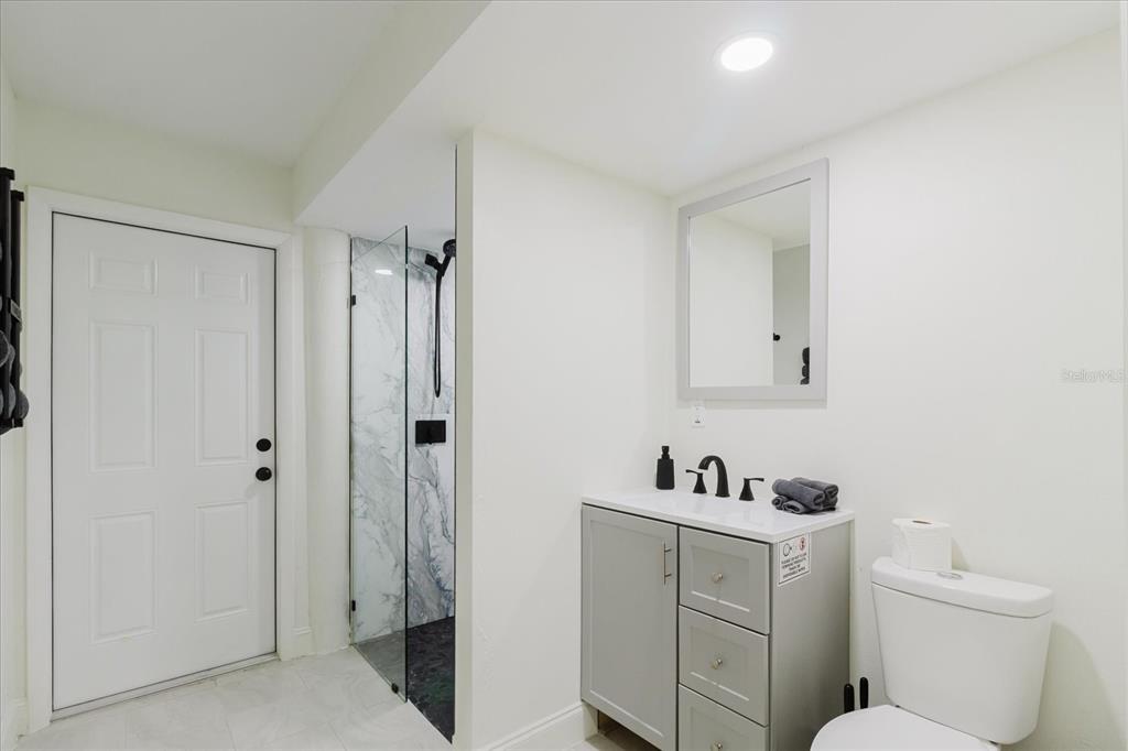 8304 Revels Road Riverview, FL 33569 - Photo 53 of 99 a bathroom with a toilet sink a mirror and shower