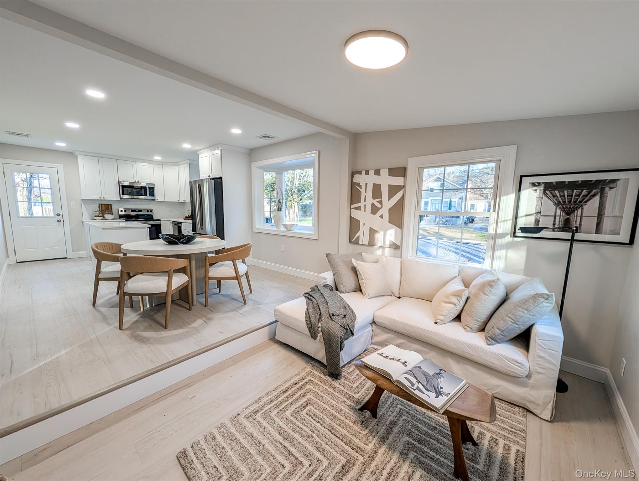 Living room with recessed lighting and light wood-type flooring