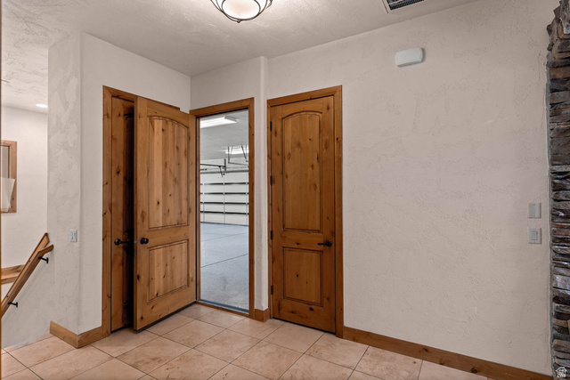 2464 East Granite Way St. George, UT 84790 - Photo 60 of 106 Foyer entrance to garage with baseboards and light tile patterned floors