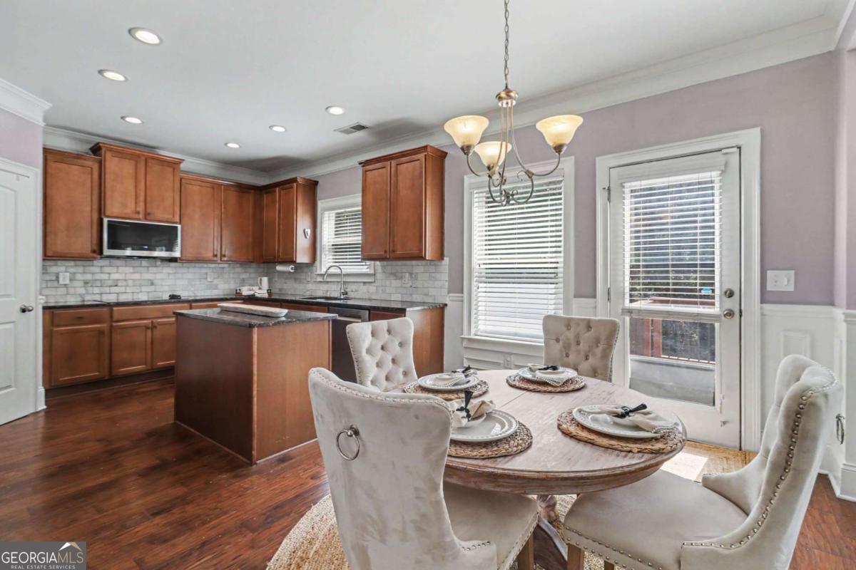 207 George Wynn Road Palmetto, GA 30268 - Photo 11 of 32 a kitchen with kitchen island granite countertop a sink counter top space and appliances