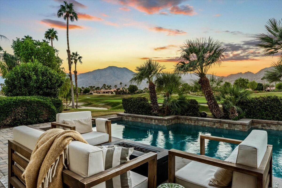 54695 Winged Foot La Quinta, CA 92253 - Photo 2 of 51 a view of a chairs and table in patio with a lake view