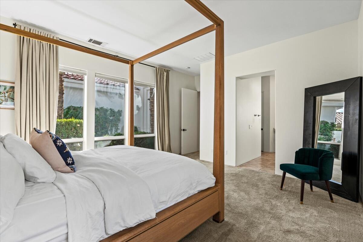 54695 Winged Foot La Quinta, CA 92253 - Photo 27 of 51 a bedroom with a bed and a large window
