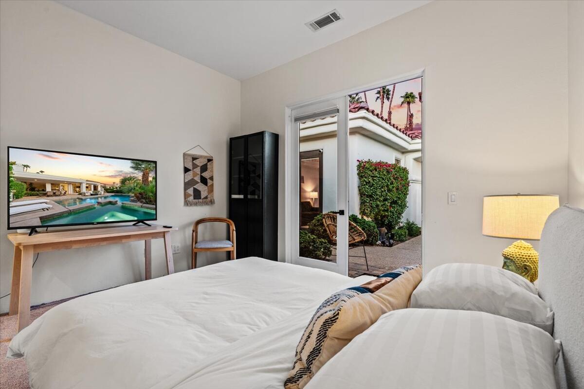 54695 Winged Foot La Quinta, CA 92253 - Photo 34 of 51 a bedroom with a large bed and a large window