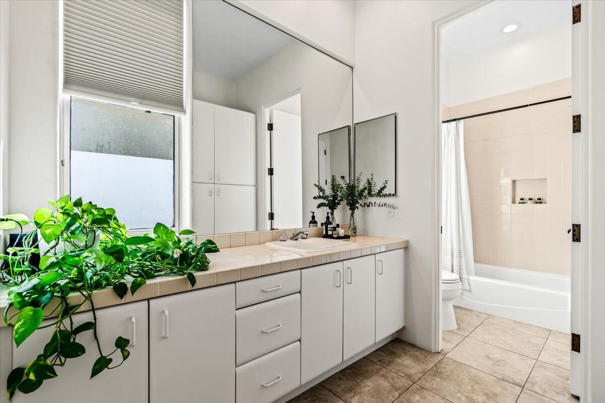 54695 Winged Foot La Quinta, CA 92253 - Photo 36 of 51 a bathroom with a shower sink and mirror